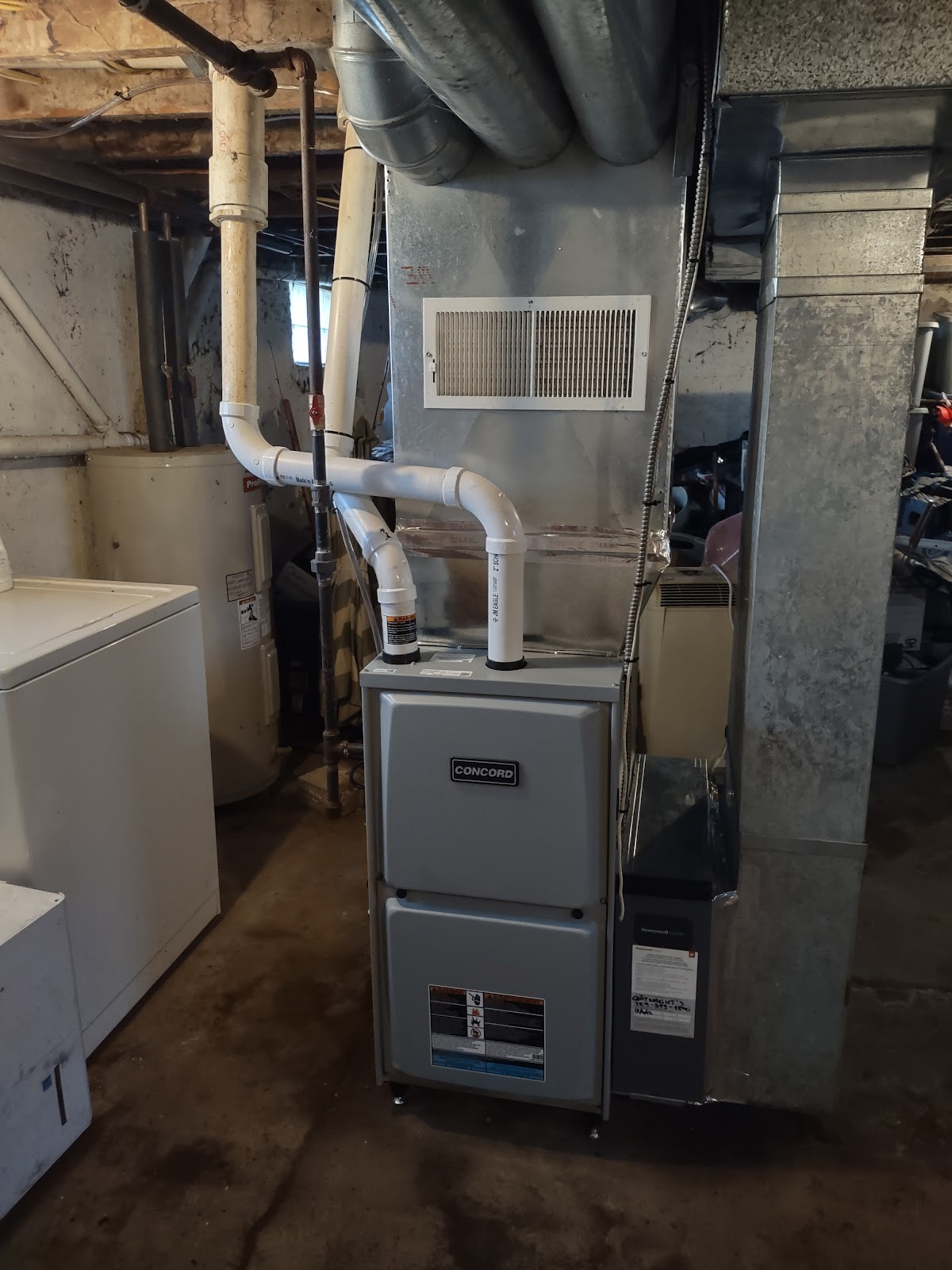 Concord gas furnace installed in a basement mechanical room with new ductwork and venting